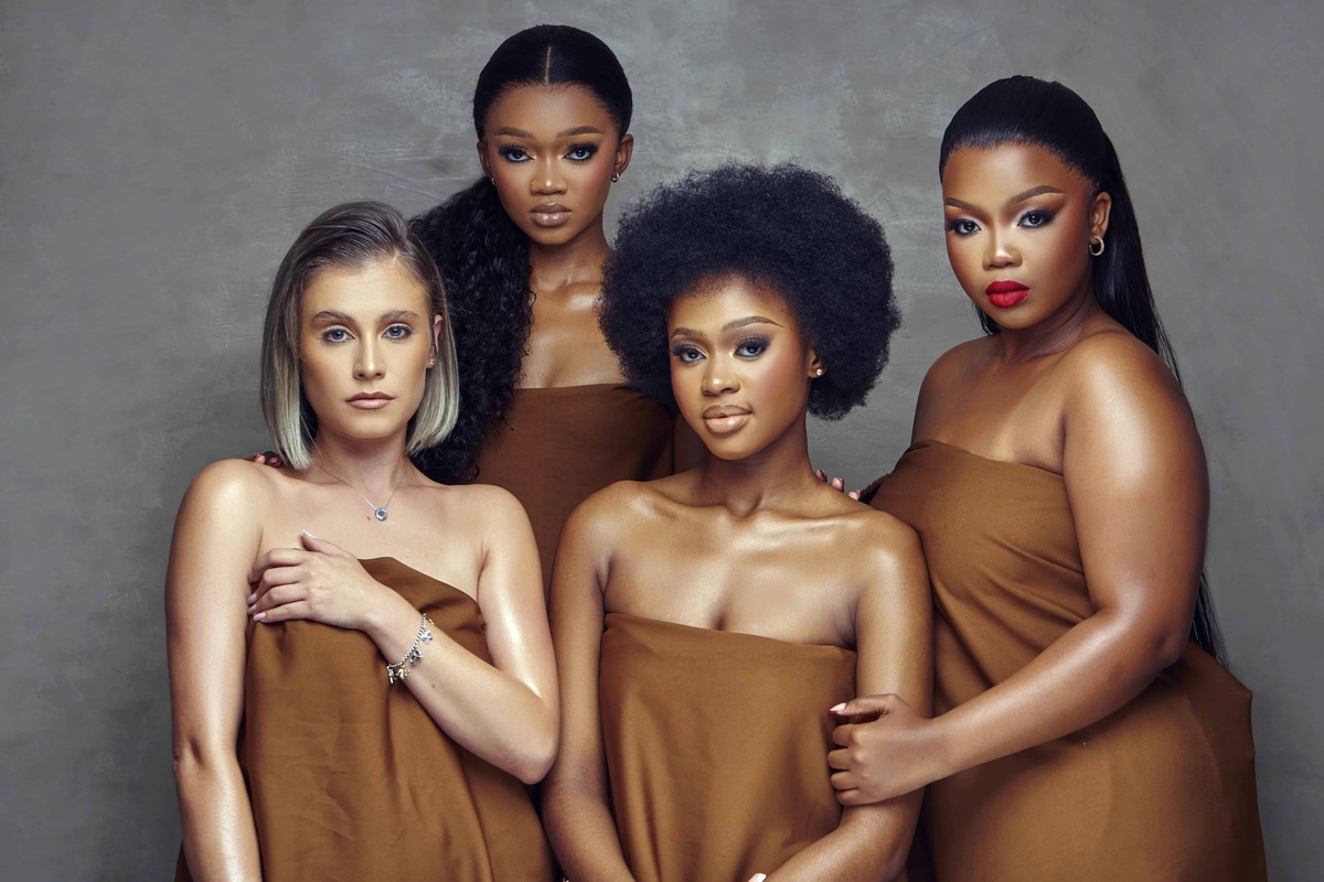 Group of diverse women in bronze wrap dresses